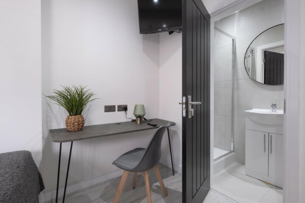 This stylish double bedroom features a sleek de...