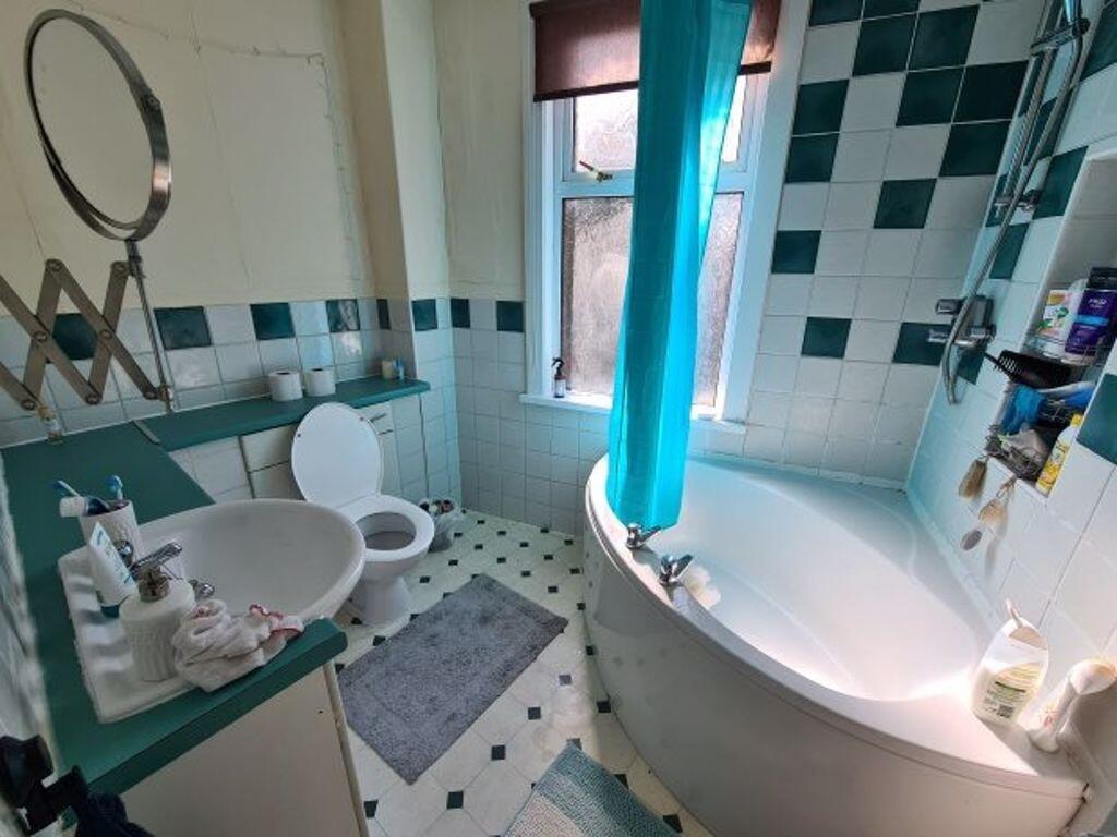 Bright and well-maintained bathroom with a larg...