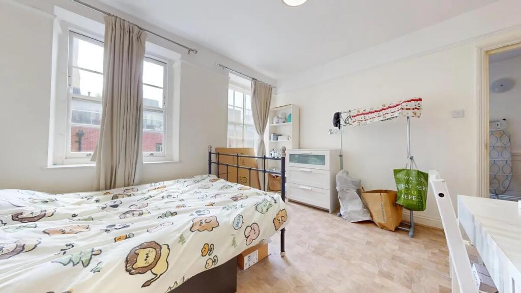 Bright and airy double bedroom featuring two la...