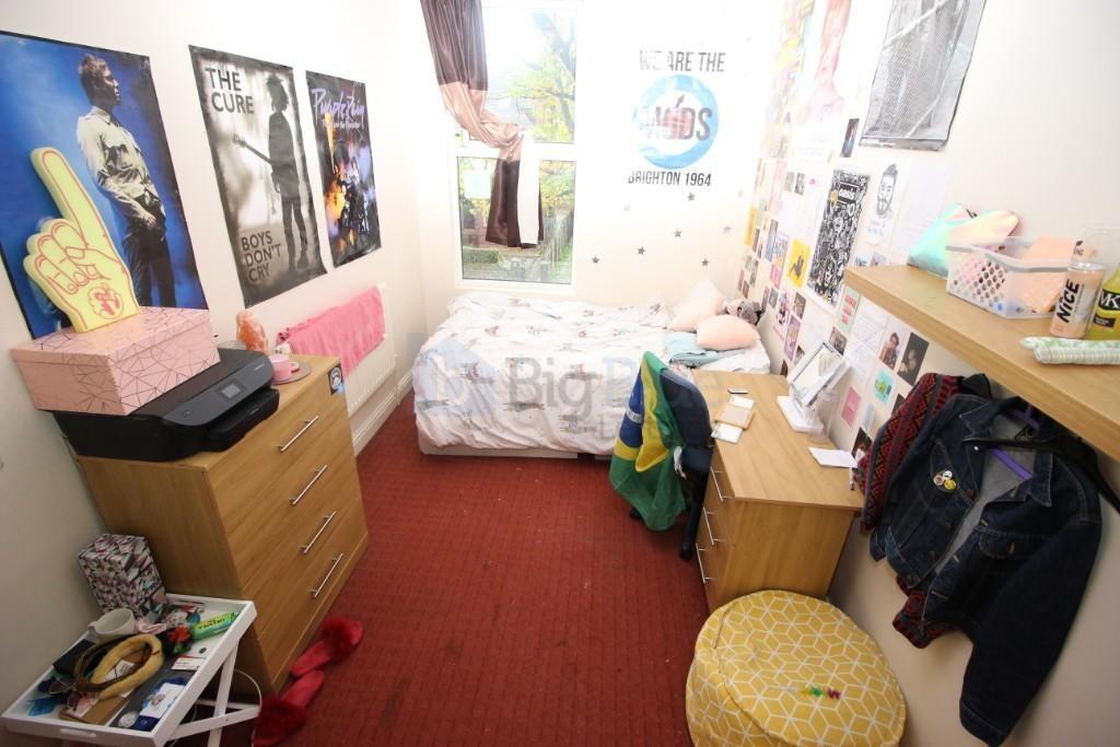 Cozy single bedroom with a comfortable bed, a d...