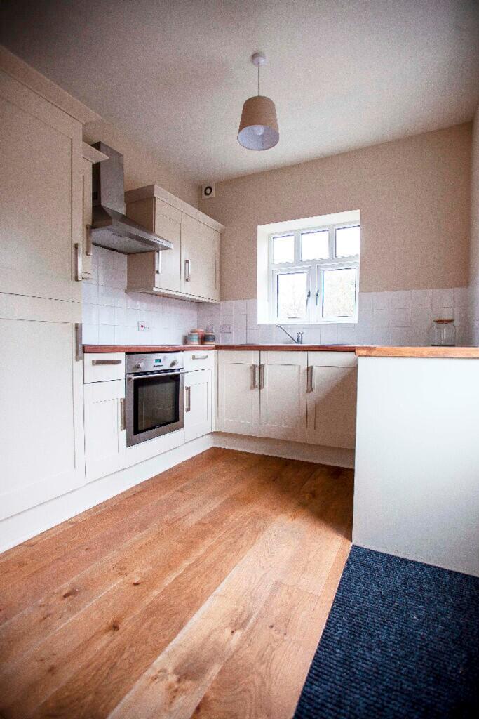 A bright and modern kitchenette featuring styli...
