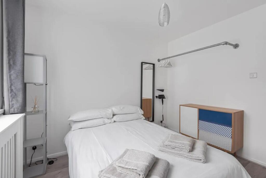 A bright and tidy double bedroom featuring a ne...