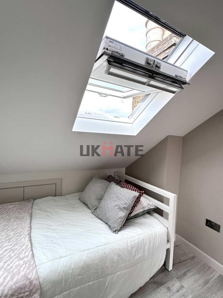 A cozy double bedroom featuring a clean, neatly...