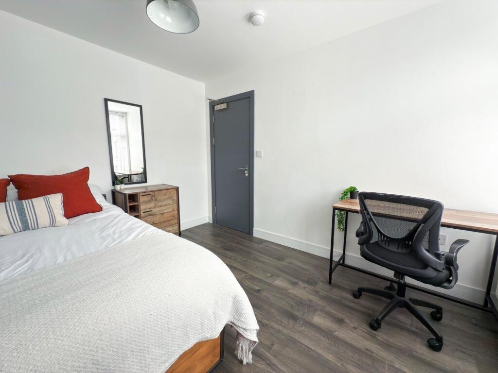 A well-maintained bedroom featuring a comfortab...