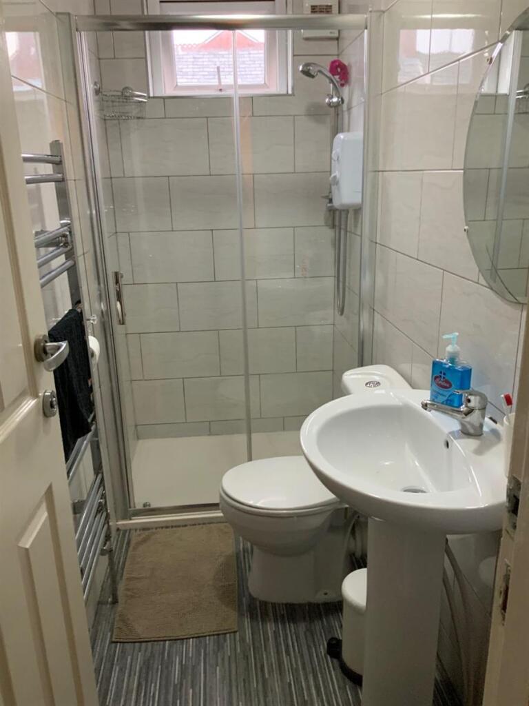 Bright and tidy bathroom with a walk-in shower,...