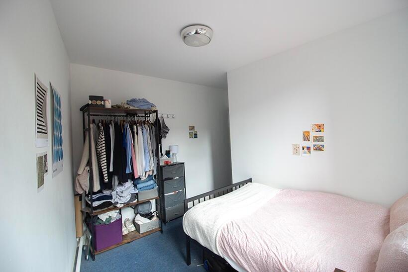 This cozy double bedroom features a comfortable...