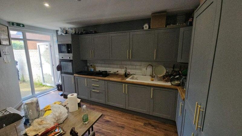 Modern kitchen featuring stylish grey cabinetry...