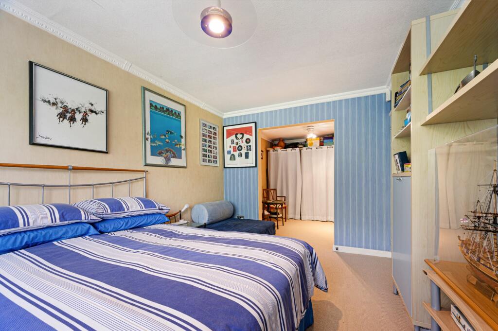 The larger bedroom with dressing area