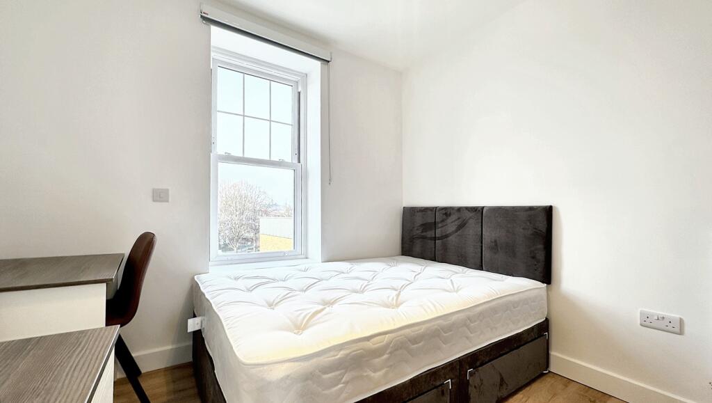 Bright and inviting double bedroom featuring a ...