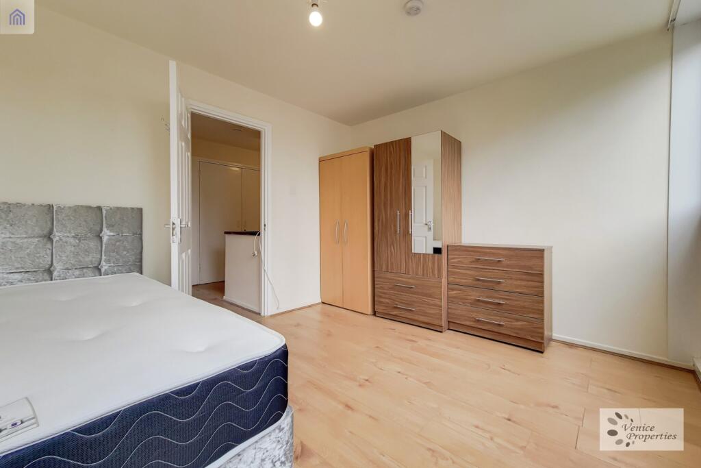 Bright and welcoming bedroom with a comfortable...