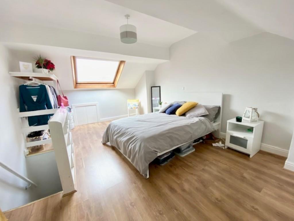 A bright and spacious master bedroom featuring ...