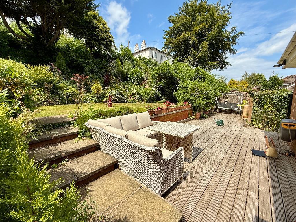 Large deck and pretty gardens