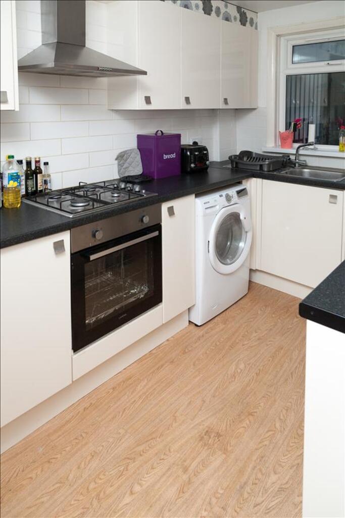 This modern kitchen features sleek cabinetry, e...