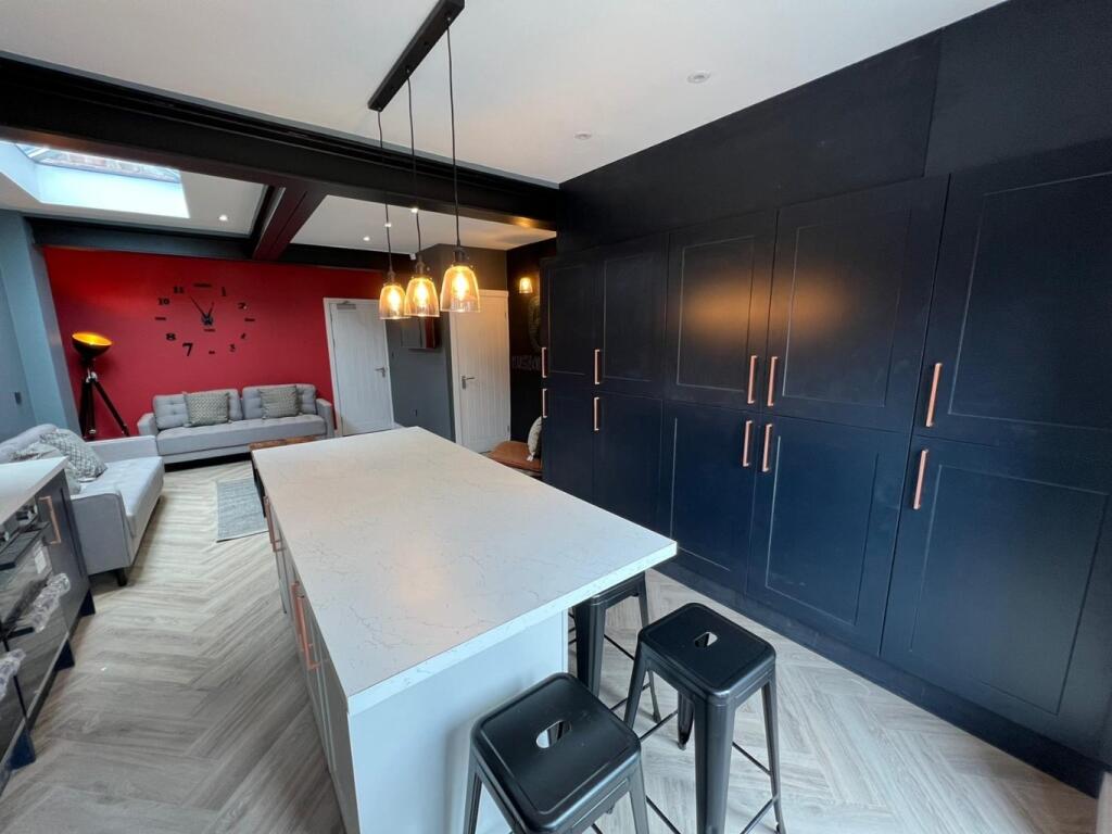 A modern, spacious living room featuring sleek ...