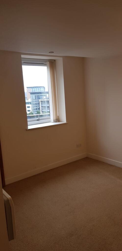 A simple, clean room with a large window allowi...