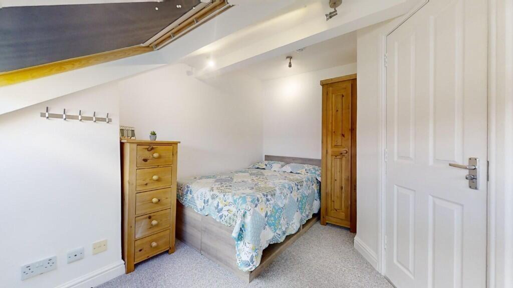 Bright and cozy double bedroom featuring a comf...