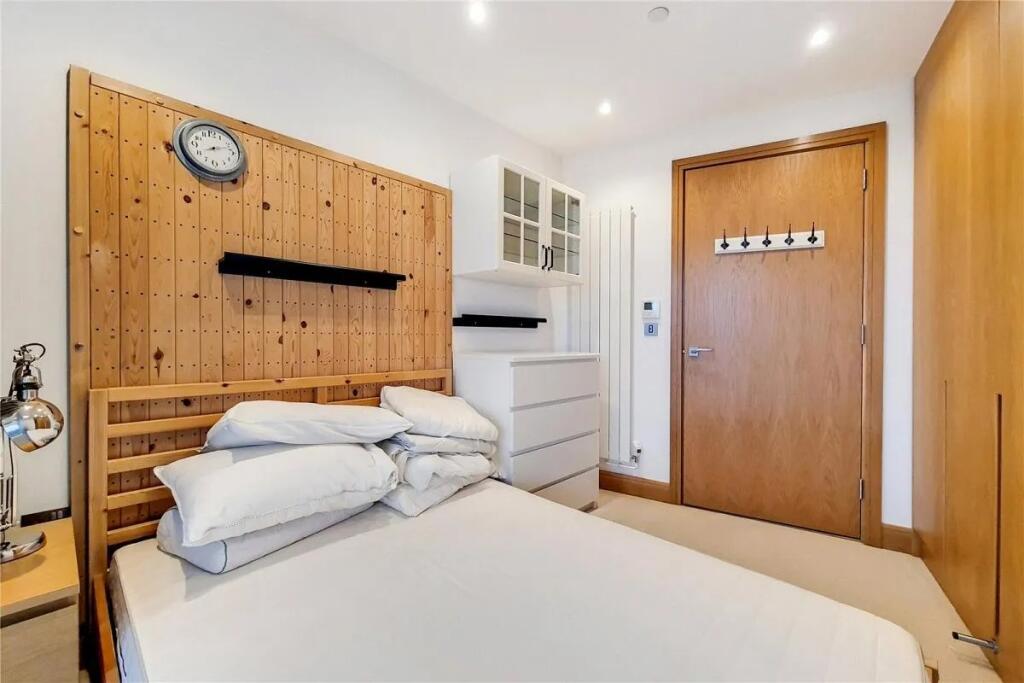 A bright and tidy double bedroom featuring a wo...