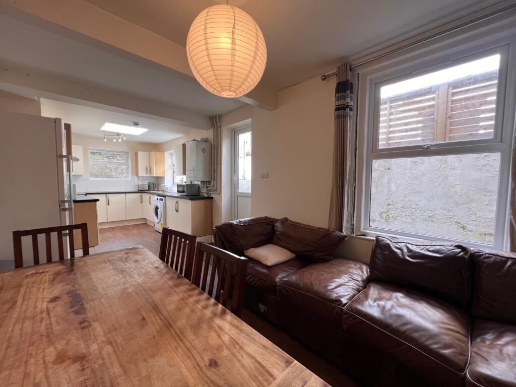 A cozy living room with a large brown leather s...