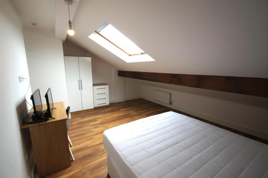 Spacious double bedroom with abundant natural l...