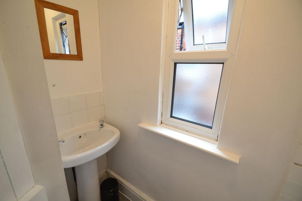 Compact and clean single toilet featuring a whi...