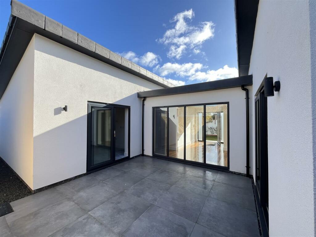 TO THE REAR OF THE PROPERTY