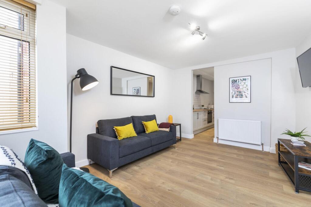 Bright, modern living room with wood flooring, ...