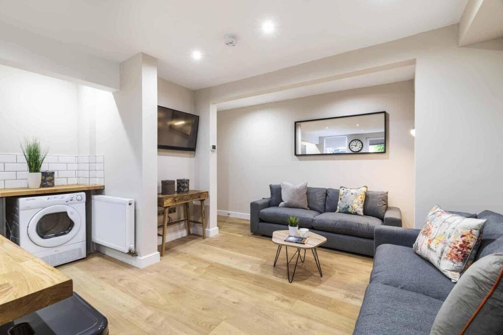 A bright and inviting living room featuring com...