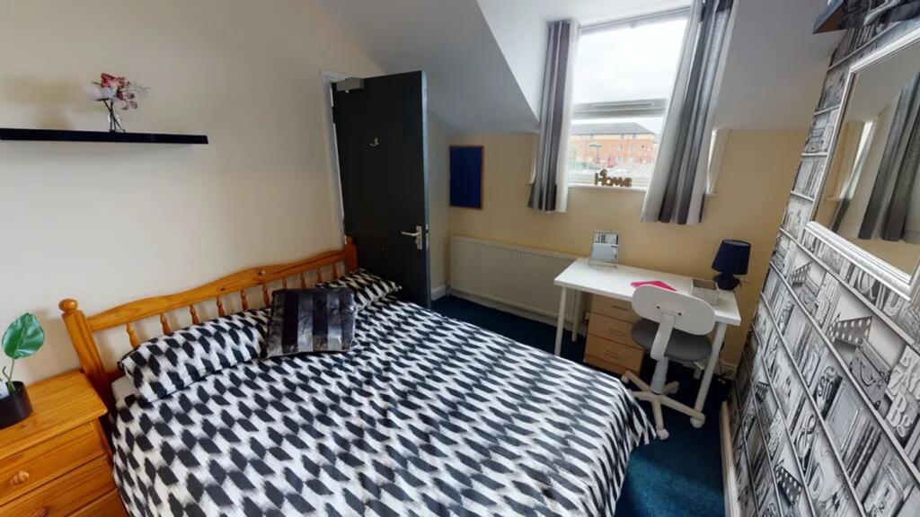 A bright and inviting double bedroom featuring ...