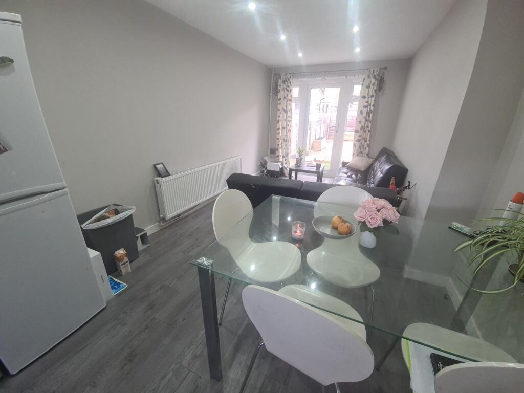 Bright and modern kitchen area featuring a glas...