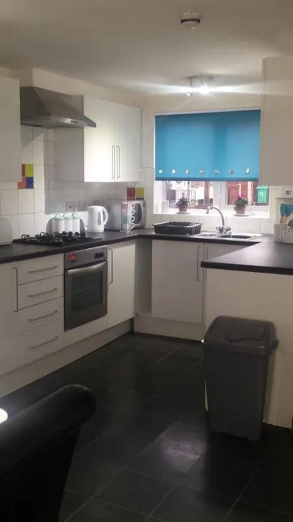 A bright and tidy kitchen with modern appliance...