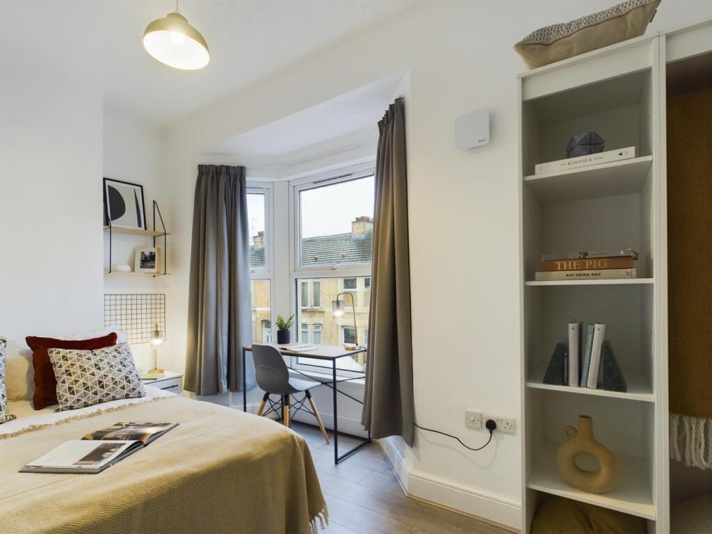 A bright and inviting double bedroom featuring ...