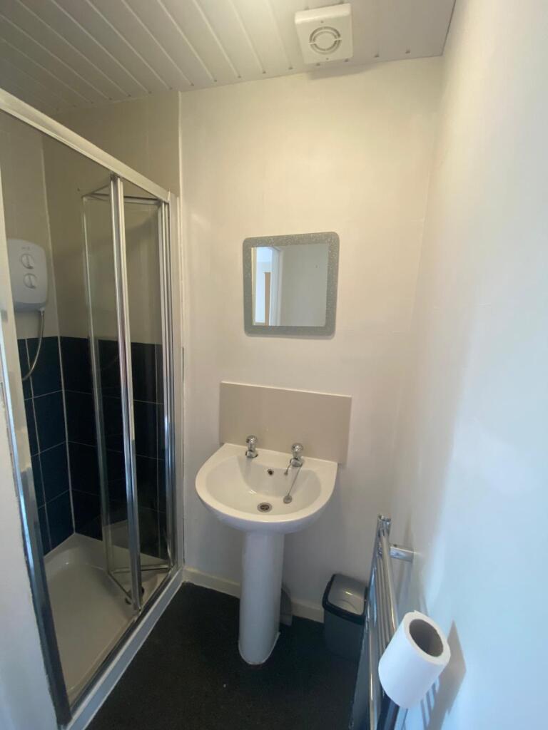 A modern bathroom featuring a sleek shower encl...