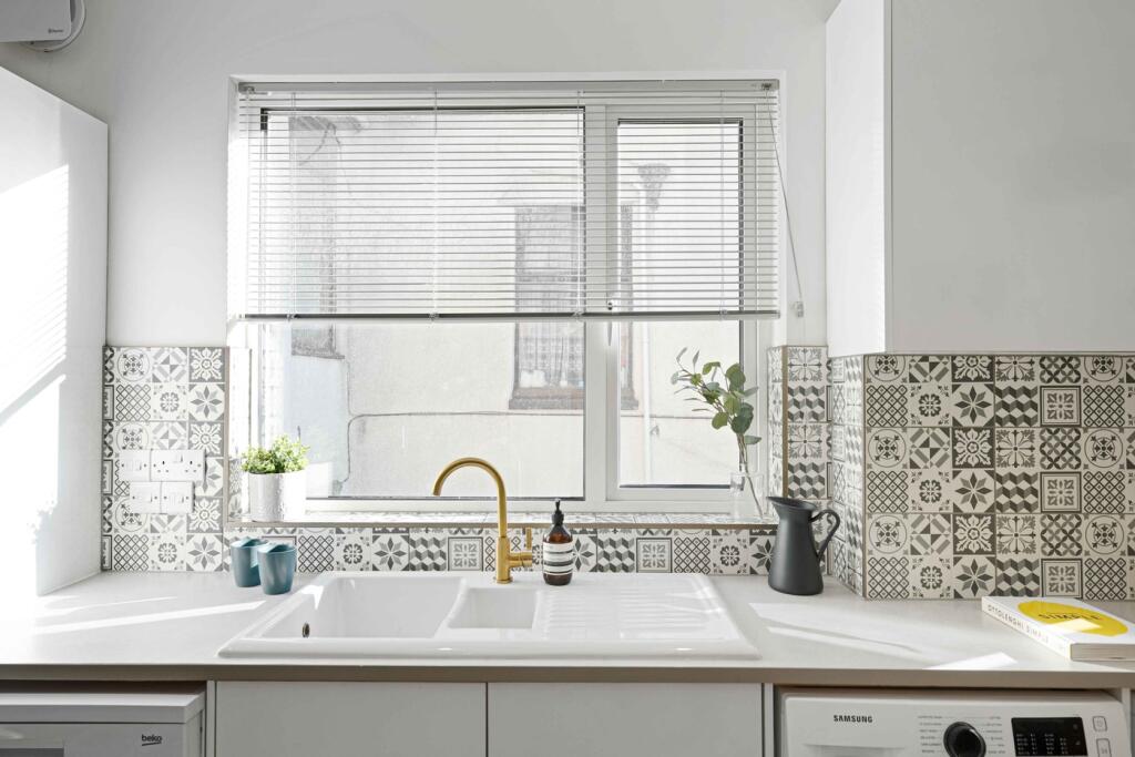 A bright and modern kitchenette featuring styli...