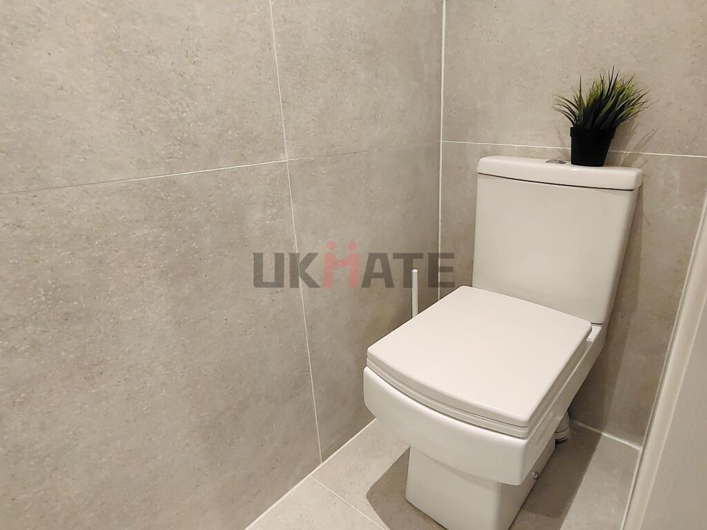 A clean, modern bathroom with neutral tiled wal...