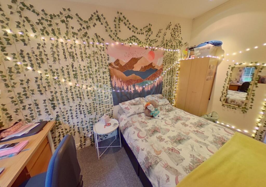 A cozy and inviting single bedroom featuring ch...