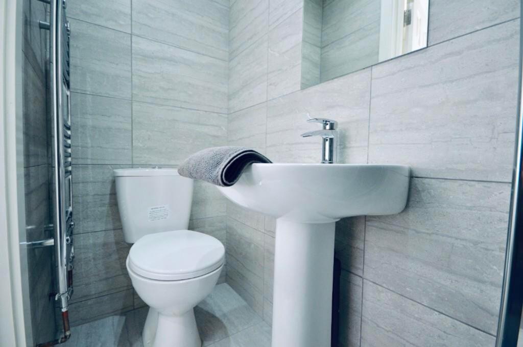 A modern and tidy bathroom featuring sleek fixt...