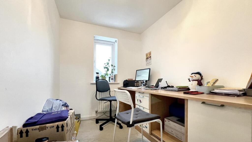 A tidy study area with good natural light, perf...