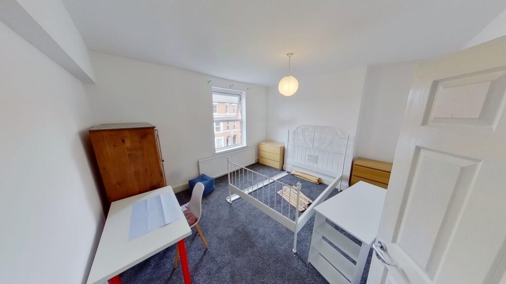 Bright and tidy double bedroom featuring a larg...