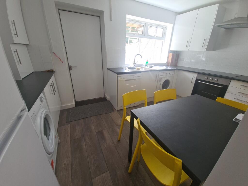 Bright and modern kitchen featuring ample count...