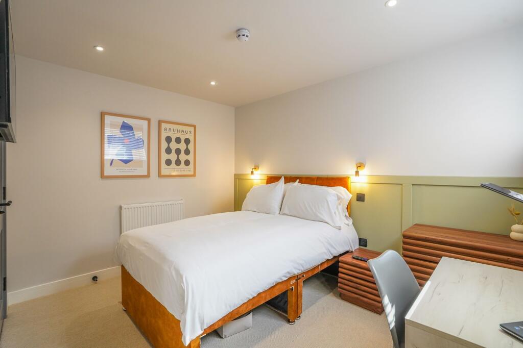 Bright and welcoming bedroom featuring a comfor...