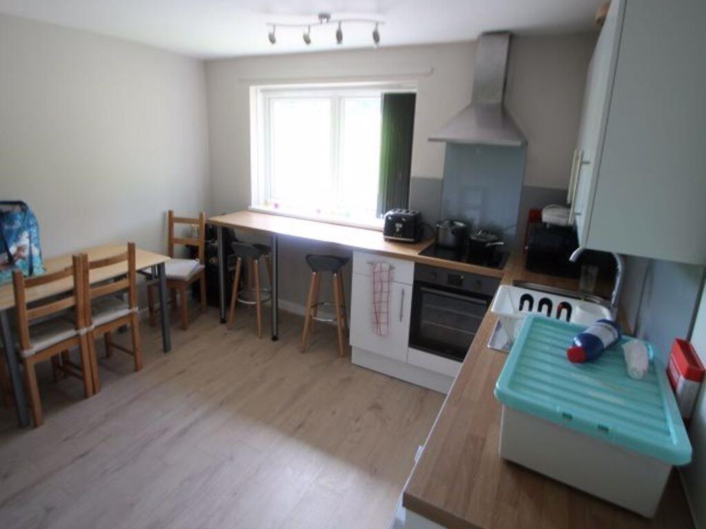Bright and tidy kitchen featuring a large windo...