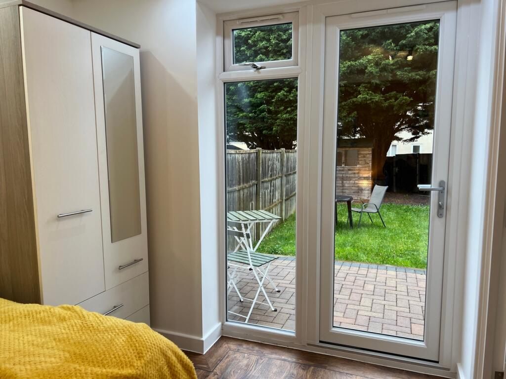 A bright and inviting double bedroom with acces...