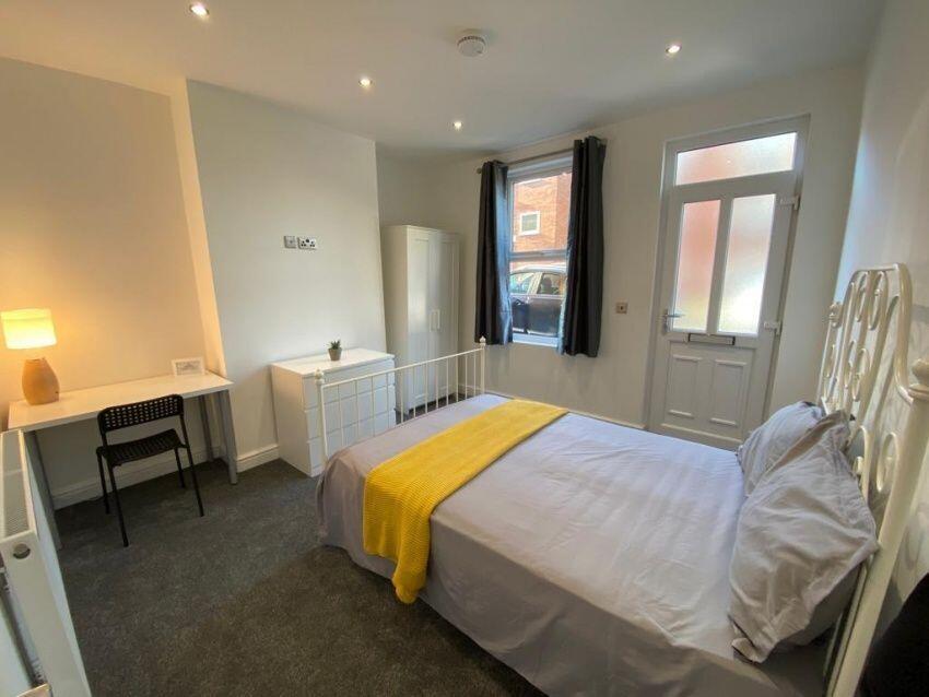 A bright and inviting double bedroom featuring ...