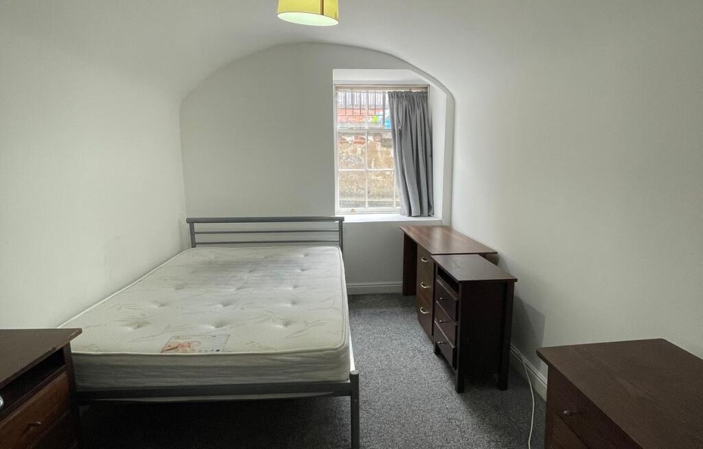 A neatly presented double bedroom featuring a m...