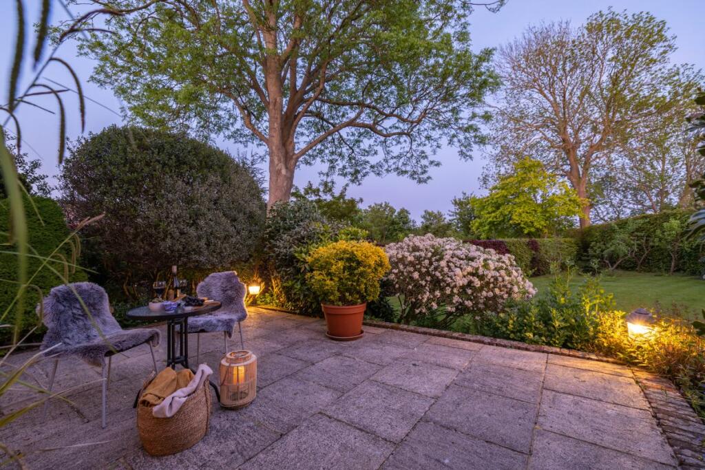 Twilight lifestyle image of the patio and garden
