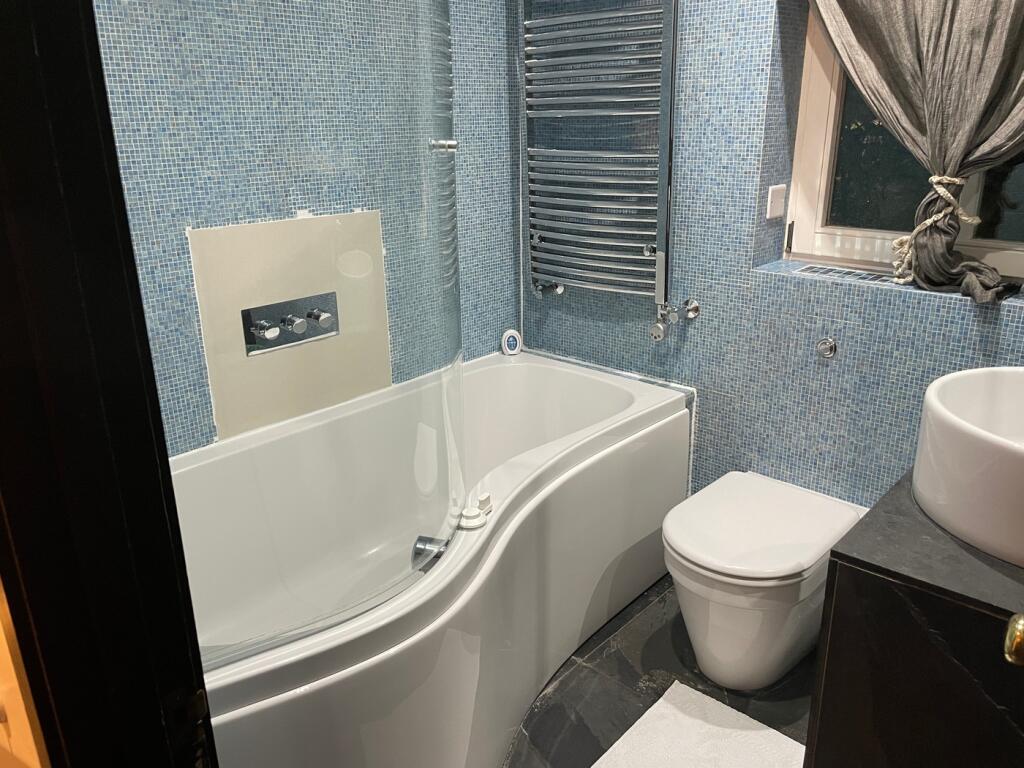 A beautifully designed large bathroom featuring...