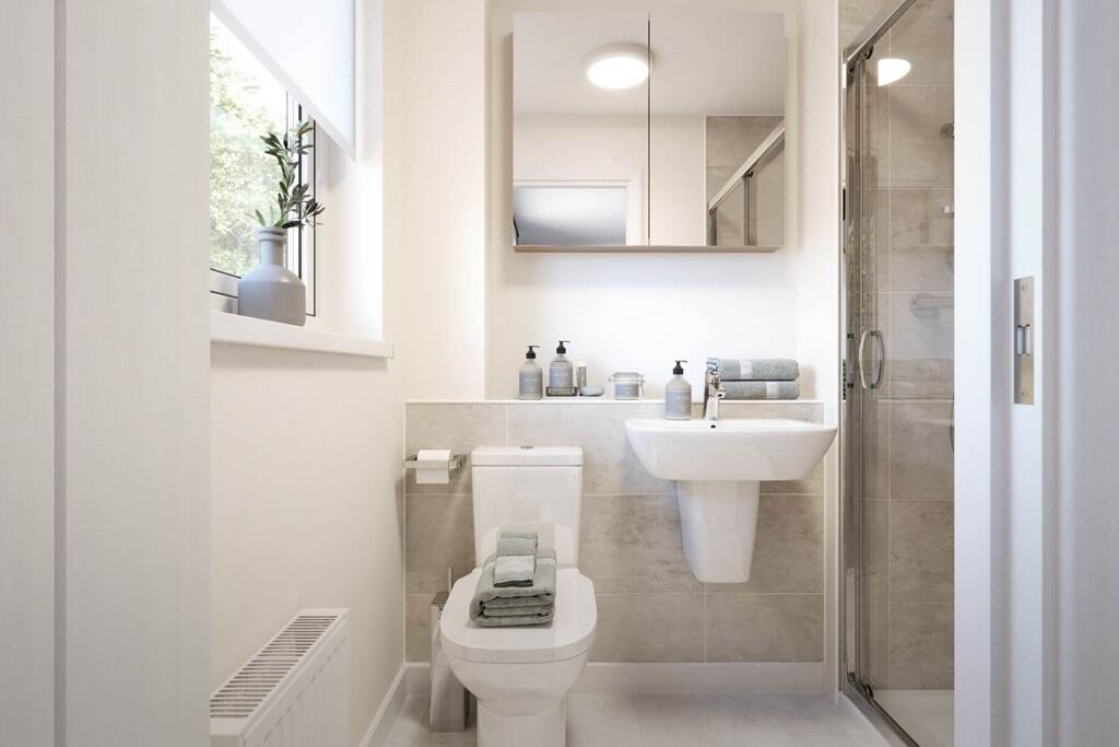 A sleek en suite featuring a modern shower and contemporary fittings, designed for comfort