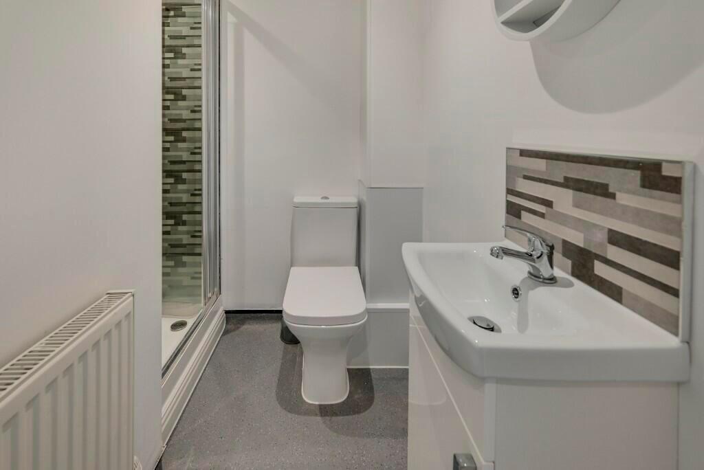 Bright and modern bathroom featuring a clean wh...