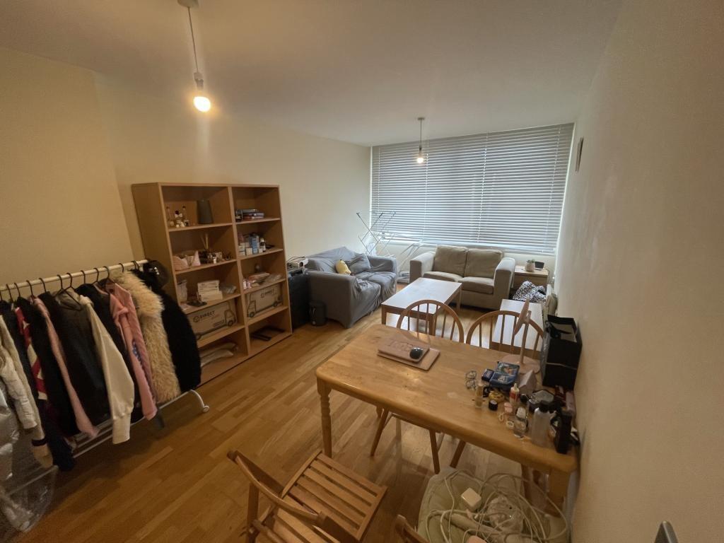 A cozy double bedroom featuring a wooden floor,...
