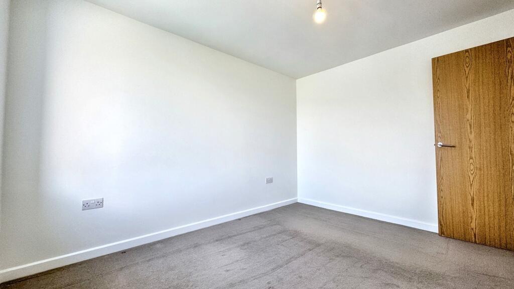 A bright and clean double bedroom featuring a l...